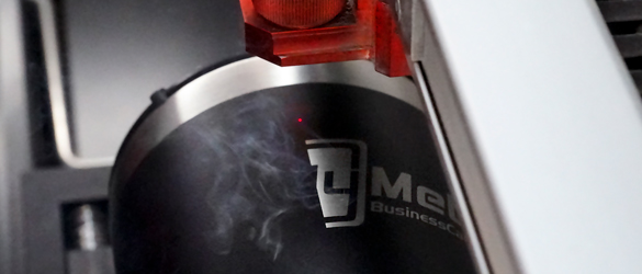 black metal tumbler being laser etched