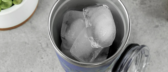 close up of ice in metal tumbler 