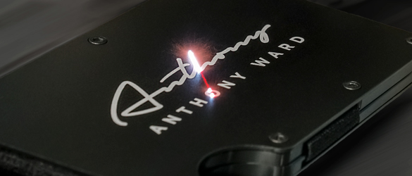 metal wallet being etched by laser beam