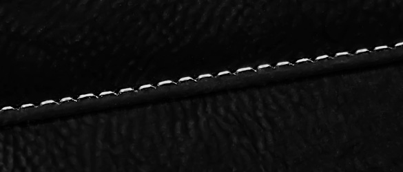 close up of stitching in black leatherette