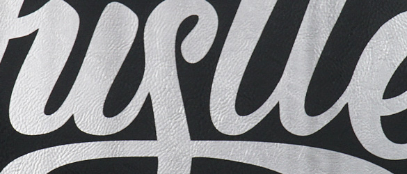 close up of etching on black leatherette