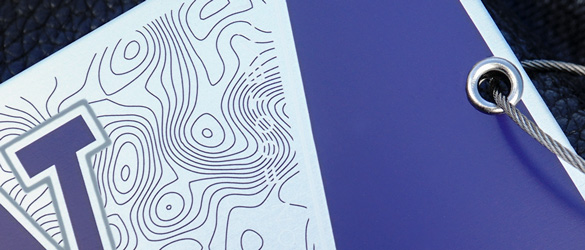 close up of screen printing on metal luggage tag