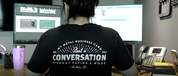 Graphic Designer Working on metal business card order