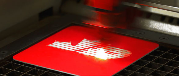 close up of etching on red silicone coaster by laser
