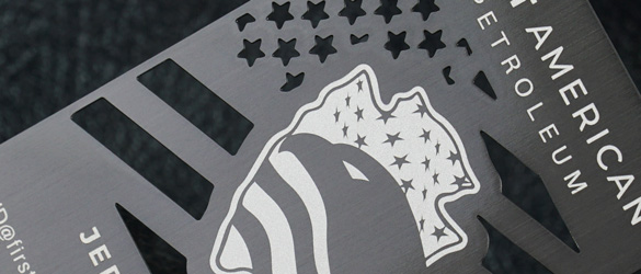 Close up of cut through areas on a black metal business card