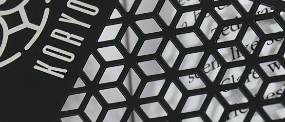 quick metal business cards chemically etched showing varying examples of cut out areas