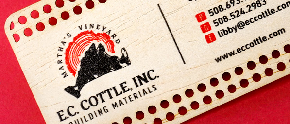 close up of cutouts in stainless steel business card