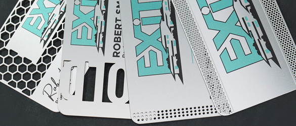 quick metal business cards chemically etched showing varying examples of cut out areas
