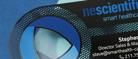 Close up of cut through areas on a black metal business card