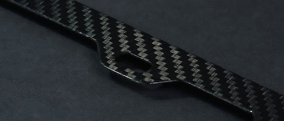 close up details of carbon fiber license plate frame finish