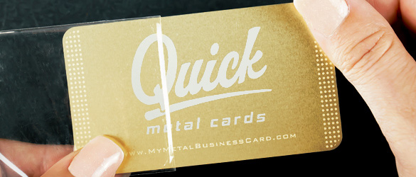 Brass Quick Metal Card in a clear sleeve being held in two hands